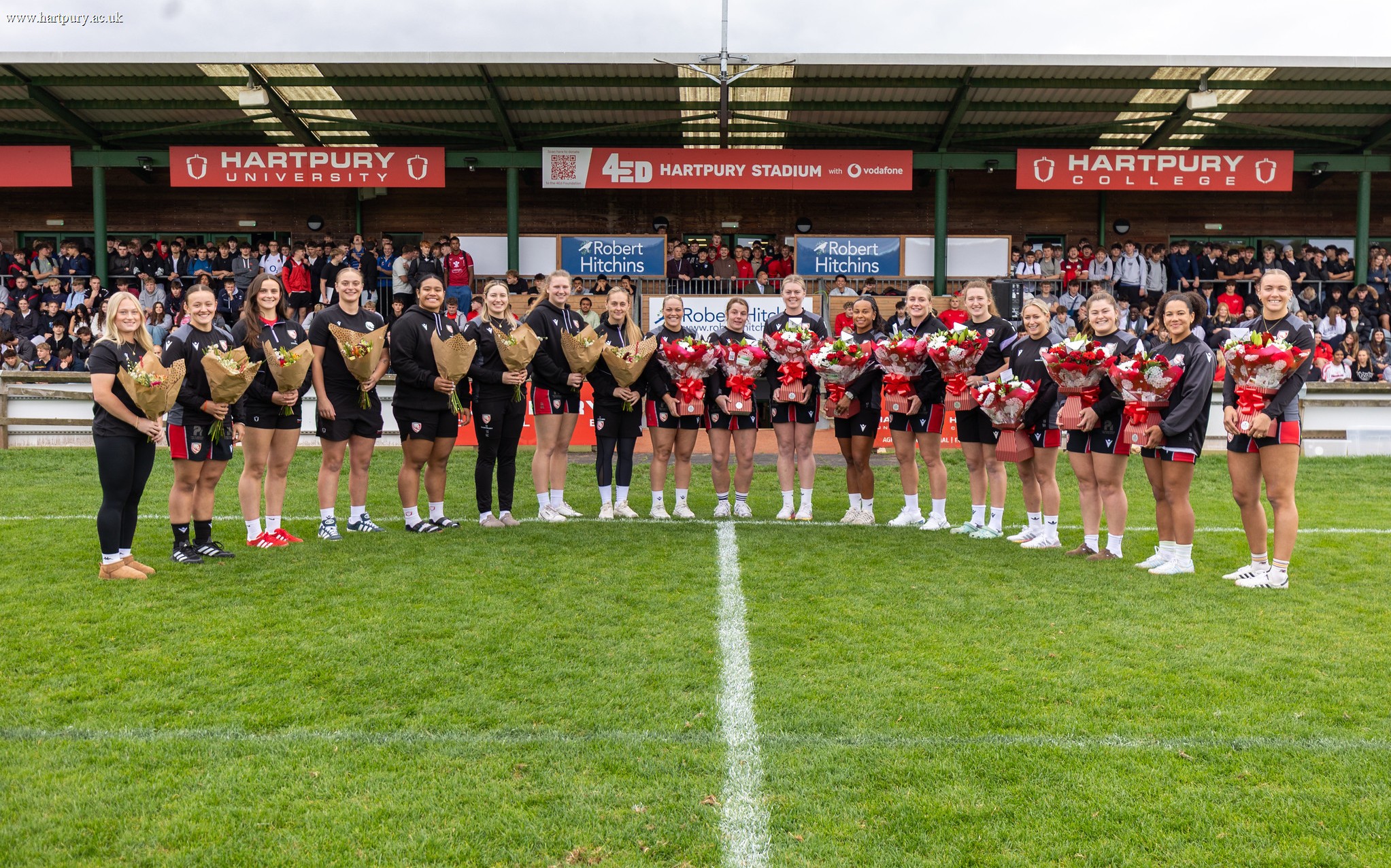 Women's Rugby World Cup players receive flowers at the 4ED Hartpury Stadium