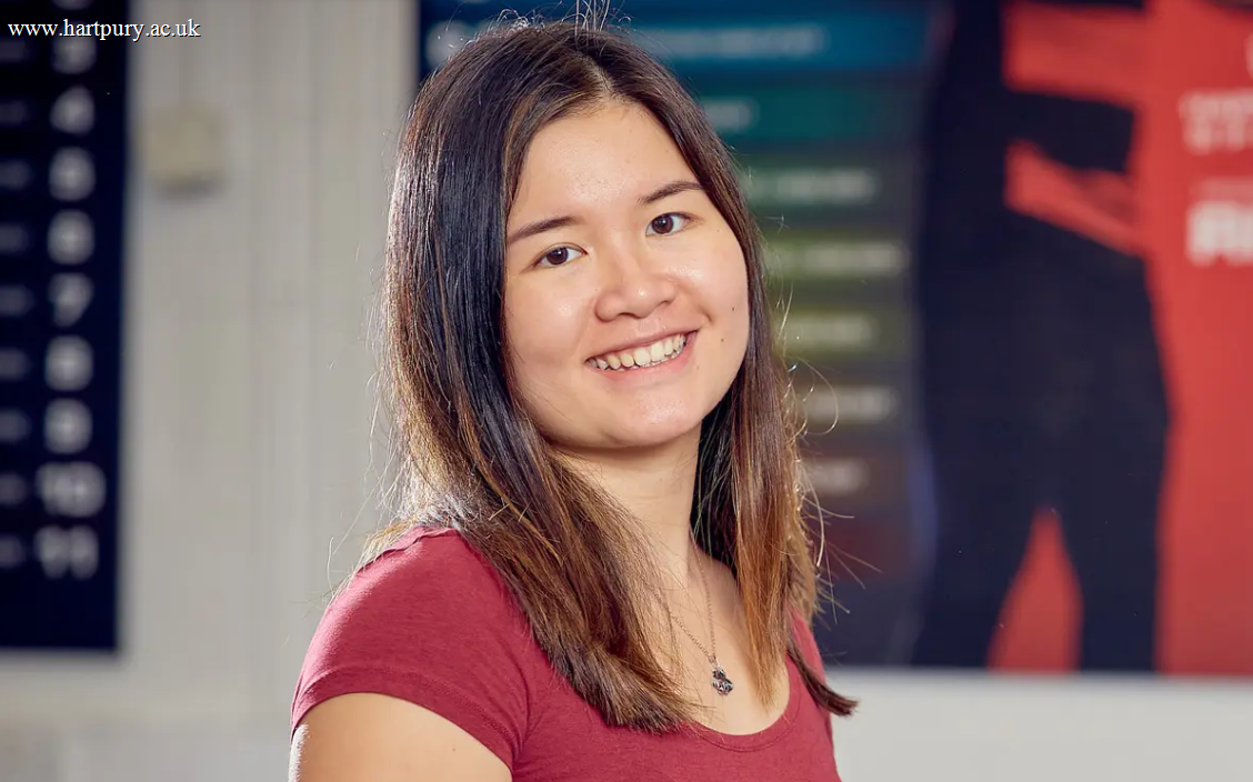 Image of a former Hartpury student smiling at the camera