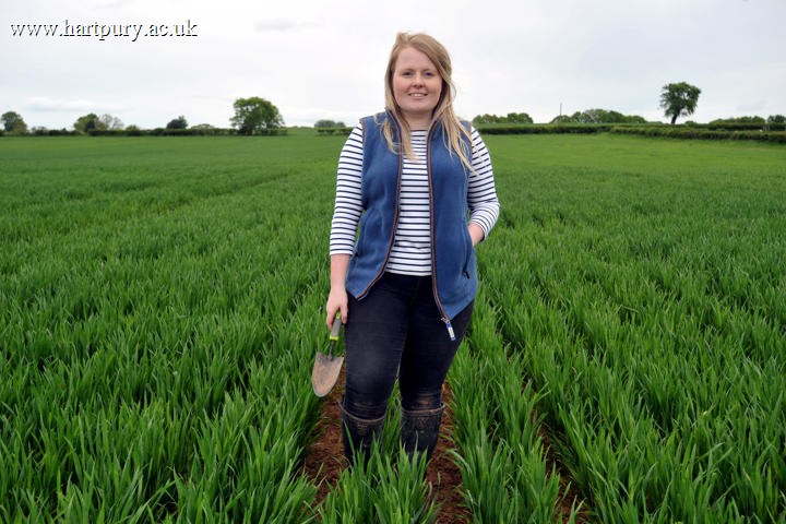 Holly Metcalfe BSc Agriculture graduate stood in field