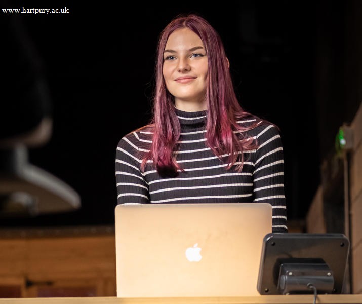 Image of student at a standing desk on their laptop whilst walking on a walking pad