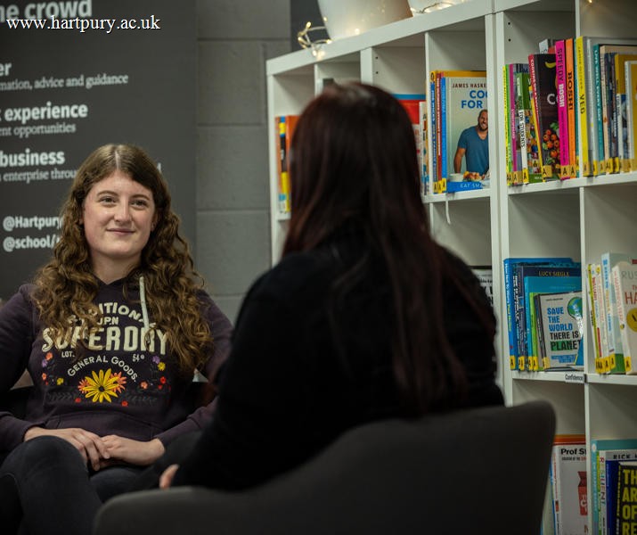 Student Support staff member sat opposite a student
