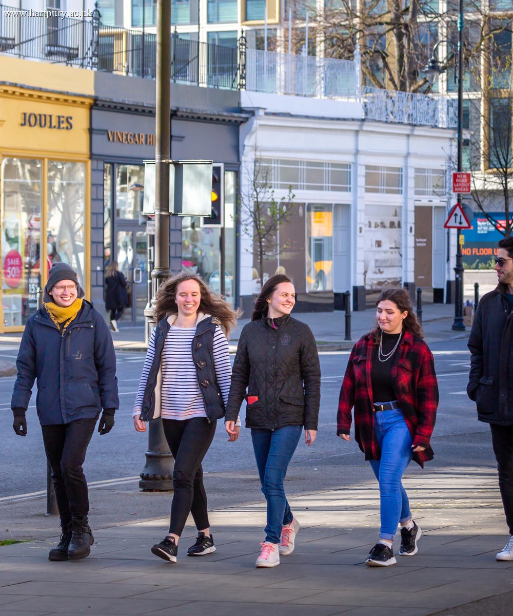 Students Walking Along Street In Cheltenham