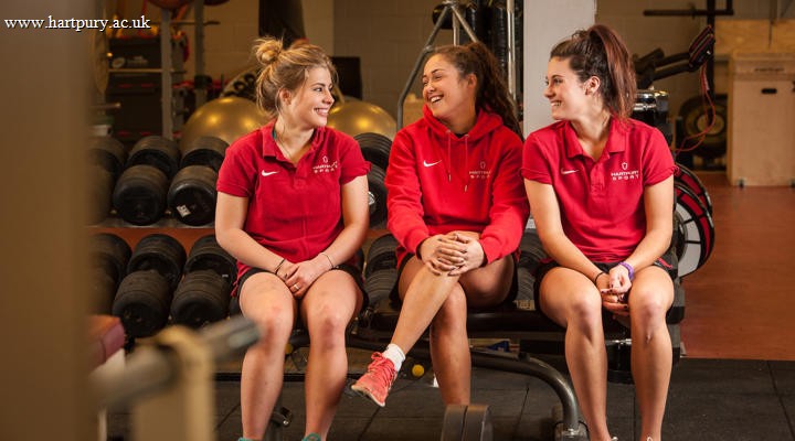 Women's Rugby College Students Sitting In Gym